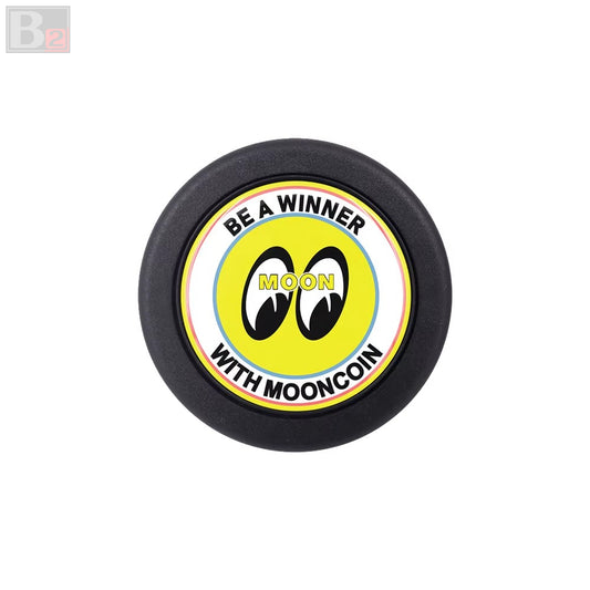 A black horn button with a yellow and white label featuring the Mooneyes logo and the text 'BE A WINNER'.