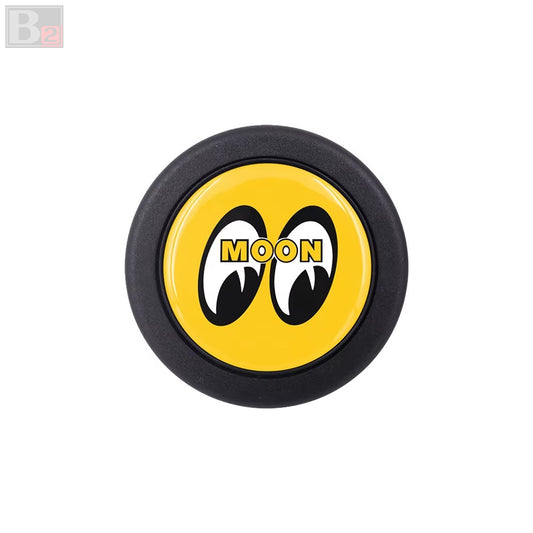 A yellow horn button with black trim, featuring the 'MOONEYES' brand logo in black.