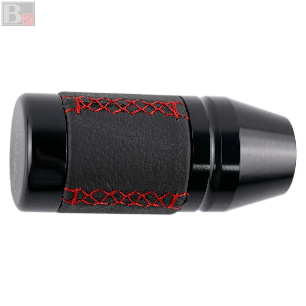 Black cylindrical object with red stitching and three smaller black cylindrical objects below on a white background.